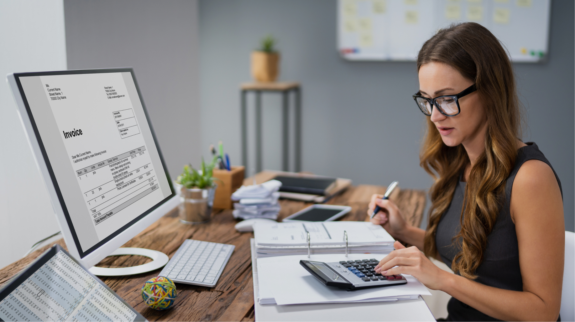 Accountant with a calculator reviewing invoices, decoding NetSuite transaction types