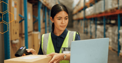 Associate scanning a box with a barcode scanner during an inventory cycle count in a stockroom